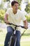 Man outdoors riding bike smiling