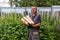 Man in overalls carries firewood