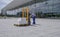 Man in overalls operates an electric stacker loaded with boxes