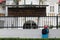 Man overlooking a building through the fence