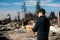 Man owner checking ruins after fire disaster.