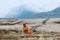 Man packing backpack travel hiking gear in mountains