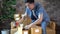 Man packing boxes at home for postal delivery