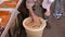 a man packs pickled cucumber into a bucket of miso at tsukiji market in tokyo