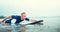 Man padding to line up on the surf board