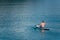 man on paddleboard in the middle of the lake