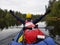 A man paddles an inflatable kayak on the river, an Adventurous kayaking experience in beautiful nature.
