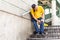 Man with painful knee struggle walking down flight of stairs