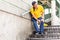 Man with painful knee struggle walking down flight of stairs