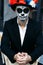 A man with a painted face of a skeleton, a dead zombie, in the city during the day. day of all souls, day of the dead, halloween,