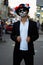 A man with a painted face of a skeleton, a dead zombie, in the city during the day. day of all souls, day of the dead, halloween,