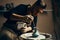 Man painting handmade pottery at ceramic workshop
