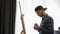 Man painting on large canvas in art studio. Painter drawing picture on easel. Art talented male student working on painting at wor