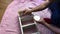 A man paints a homemade shelf with white paint. Filmed from above