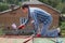 A man paints a roof