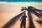 Man and palm tree shadows on tropical beach