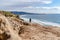 Man with panoramic view of ocean with distant pier and parachuter in San Diego