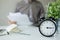 Man with papers over table with alarm clock laptop