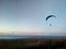 A man on a parachute descends over the Volga River, Russia
