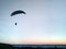 A man on a parachute descends over the Volga River, Russia