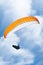 Man, parachute and paragliding in blue sky for flight, freedom and courage with extreme sport. Athlete, glide and
