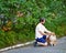 Man in the park with his pet Sheltie dog breed.