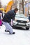 A man participates in the competition for the holiday Maslenitsa and drags a lightweight LADA car on a rope. City of Cheboksary,