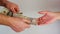 A man passes paper money American dollars to a woman. Paper money in hand. Close-up on hands on a light background