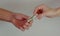 A man passes paper money American dollars to a woman. Paper money in hand. Close-up on hands on a light background