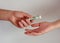 A man passes paper money American dollars to a woman. Paper money in hand. Close-up on hands on a light background