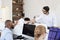 Man passing document in busy open plan office, close up