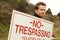A Man Passing No Trespassing Sign