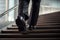 Man in patent leather shoes. Feet go down stairs. Successful person walking to business meeting. Businessman wearing