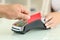 Man paying with credit card reader in a shop