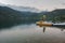 Man on pedalo or paddle boat chilling out on Italian Scanno mountain lake