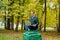 A man on a pedestal who pretends to be a statue in the the autumn park.