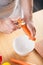 Man peeling carrot in kitchen