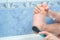 Man is peeling his foot sitting in bathroom at home, closeup view.