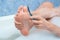 Man is peeling his foot and toes sitting in bathroom at home, closeup view.