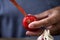 Man peeling a scalded tomato