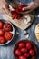 Man peeling some scalded tomatoes