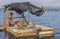 A man peels mussels on a primitive boat or raft on a mussel farm in Saranda, Albania. Fresh ecological seafood