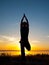 Man performing asana at sunset