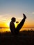 Man performing asana at sunset