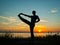 Man performing asana at sunset