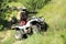 Man performing trick with modern quad bike outdoors. Extreme sport