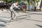 man performs amateur stunts on roller skates in a special roller park in the city