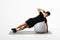 man performs side plank exercise on balance ball, white background