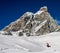 Man performs a snowboarding freestyle trick with the Matterhorn mountain the background