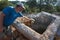 Man is petting a dog on ancient rock tomb ruins along the Lycian way hiking trail, Trekking in Turkey